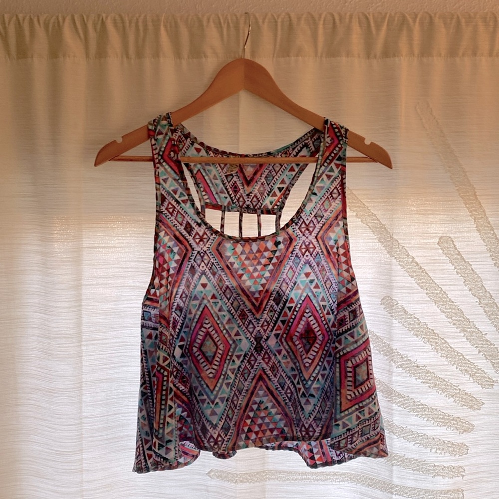 Semi-sheer crop tank with colorful geo pattern and unique cut-out design on back